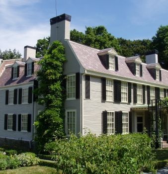 A large white house with black shutters on the windows
