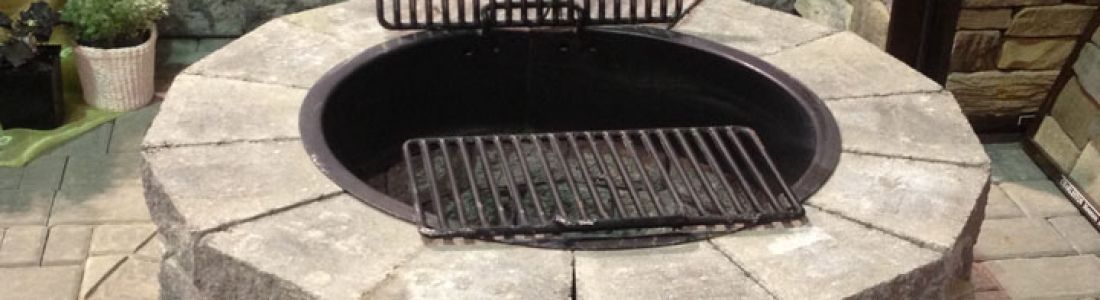 A fire pit with a grill inside of it.