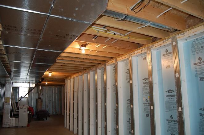 A basement under construction with a lot of walls and a ceiling.