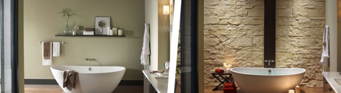 A bathroom with a tub , sink and mirror.