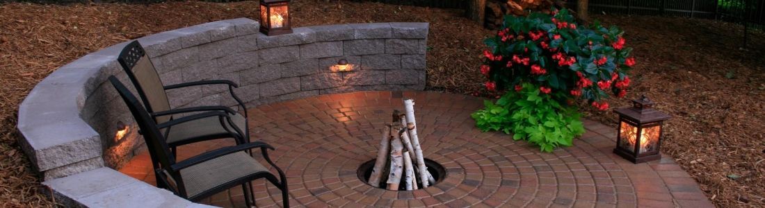 There is a fire pit in the middle of the patio.