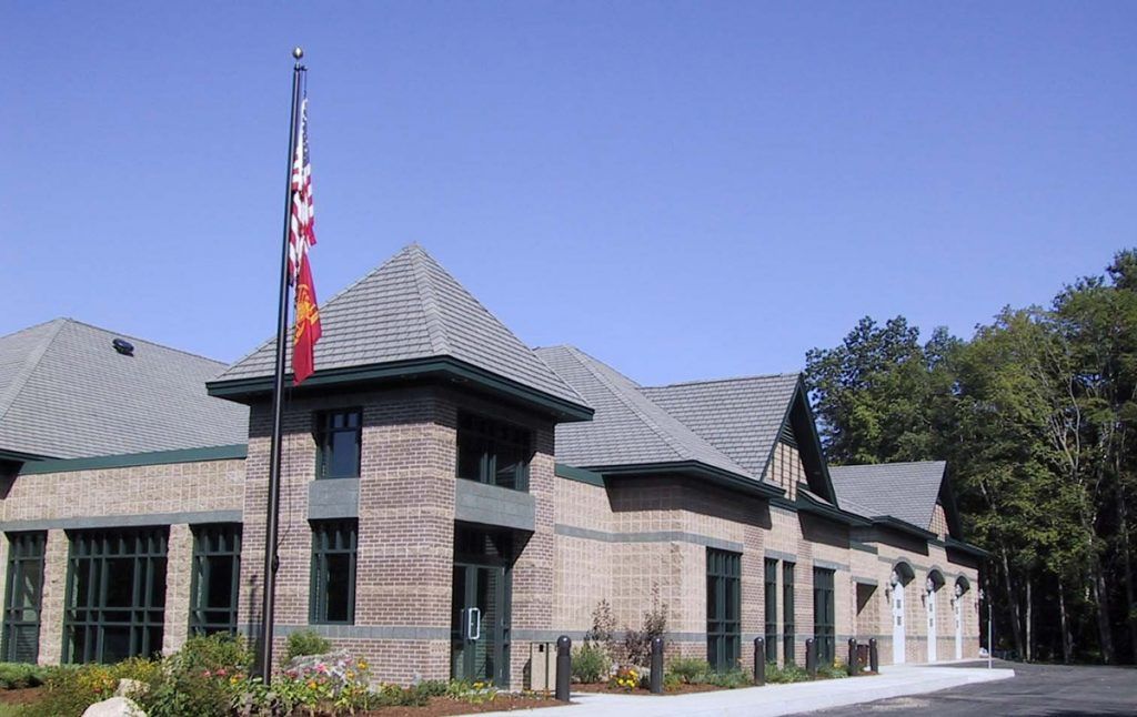 A large building with a flag flying in front of it