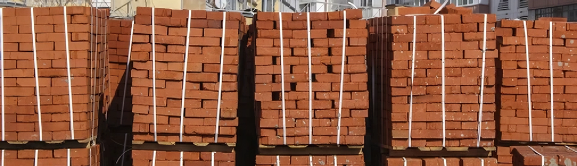A bunch of bricks stacked on top of each other on pallets.