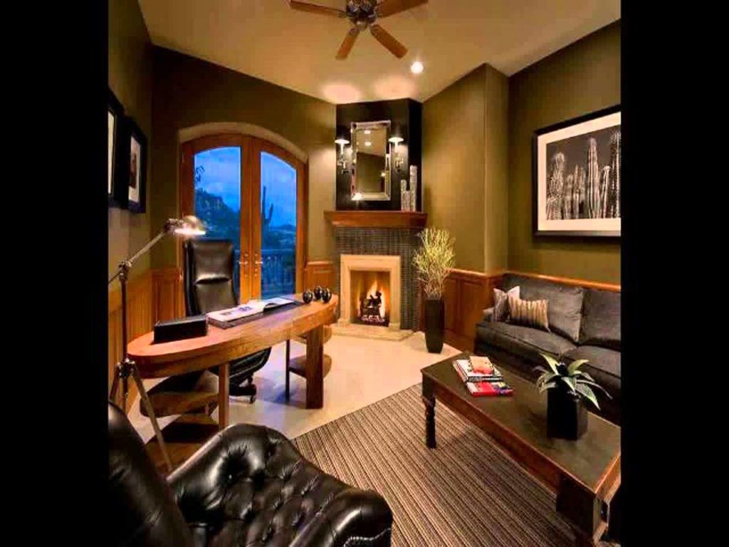 A living room with a desk , chair , couch , coffee table and fireplace.