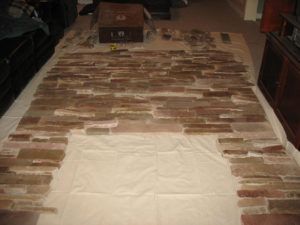 A brick fireplace is being built in a living room