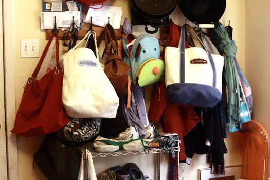 A bunch of handbags are hanging on a rack