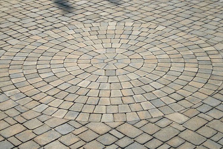 A close up of a circular pattern on a brick floor.