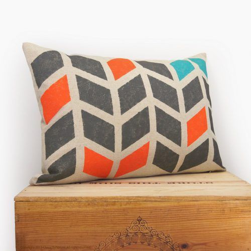 A pillow with a geometric pattern is sitting on a wooden box