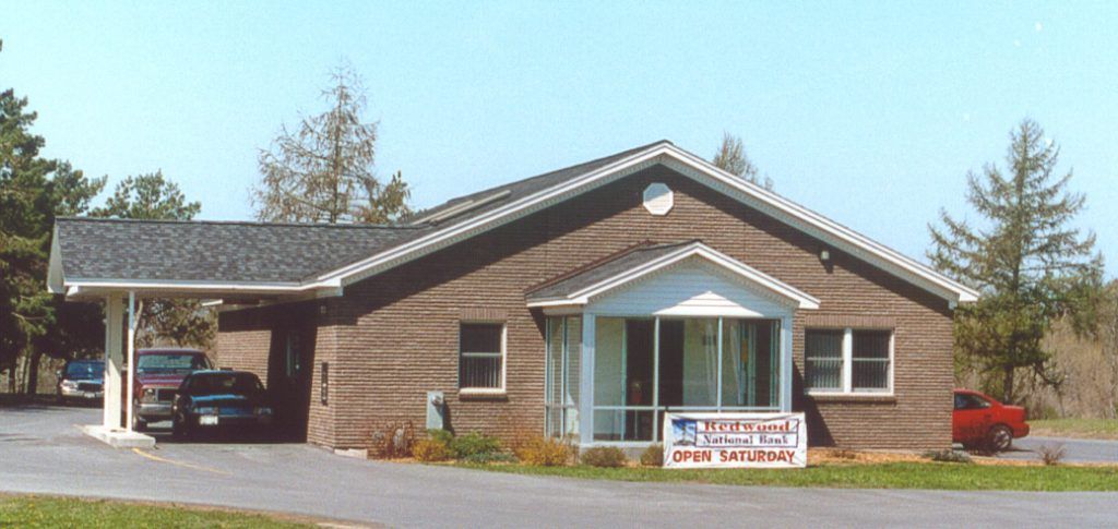 A brick house with a sign that says ' eee ' on it