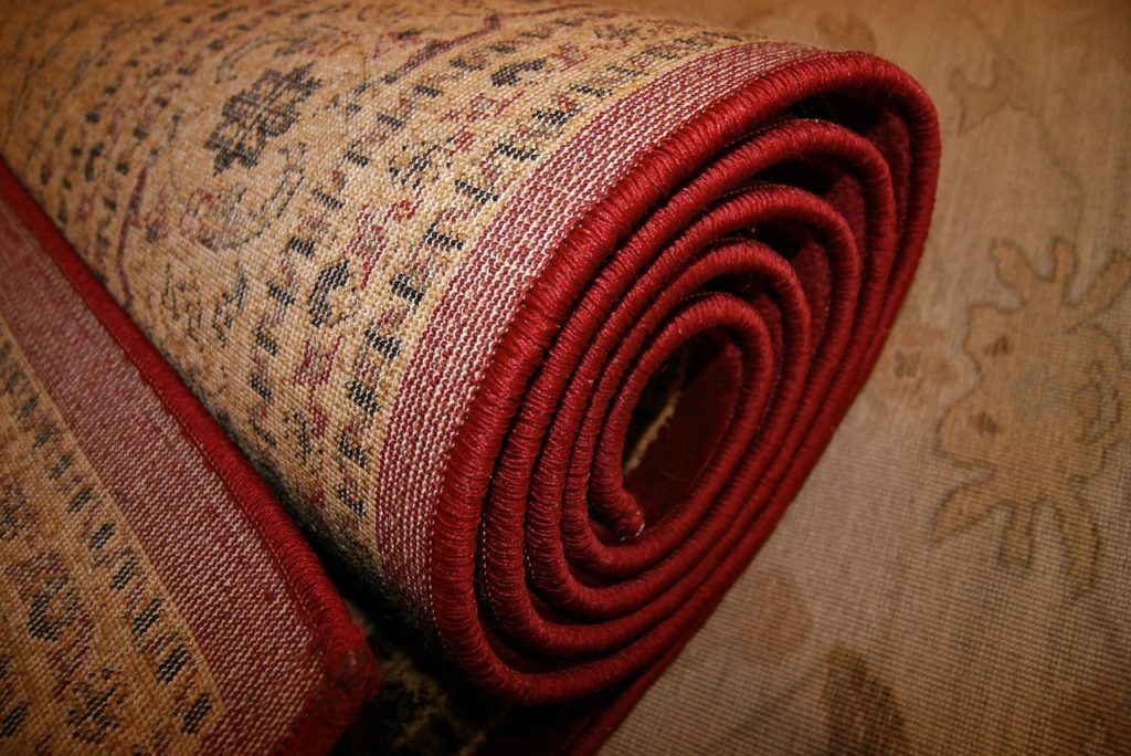 A close up of a rolled up rug on a table.
