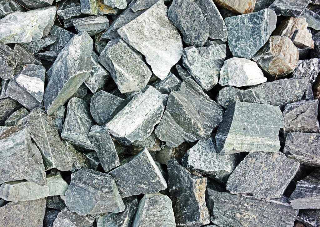 A pile of rocks is sitting on the ground.