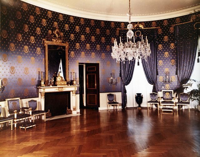 A large room with a fireplace and a chandelier