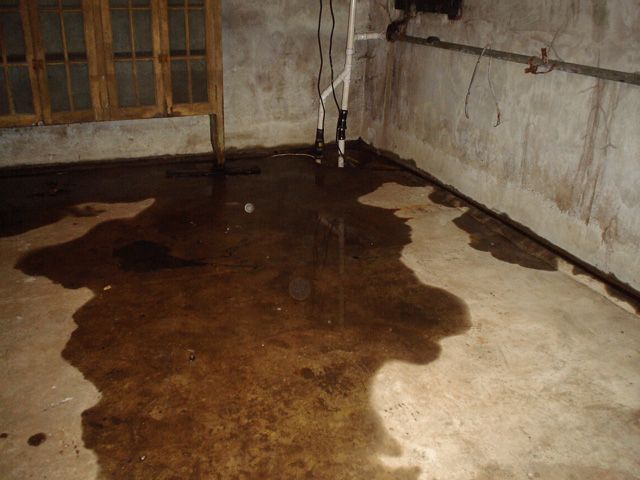 A flooded basement with a lot of water on the floor.