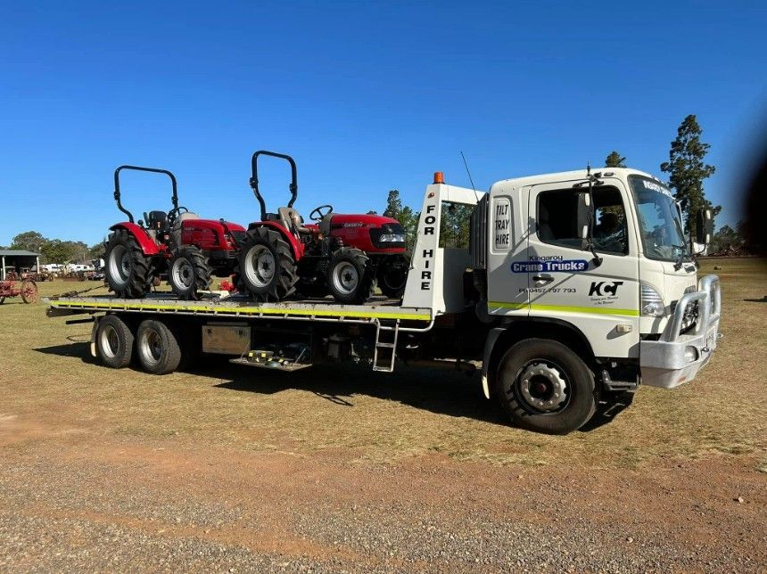 A Tow Truck With Two Tractors On The Back Of It — Kingaroy Crane Trucks & Equipment Hire In Kingaroy, QLD