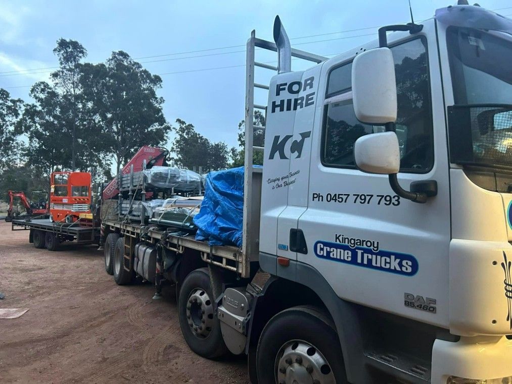 A White Truck With A Blue Tarp On The Back Is Parked — Kingaroy Crane Trucks & Equipment Hire In Kingaroy, QLD
