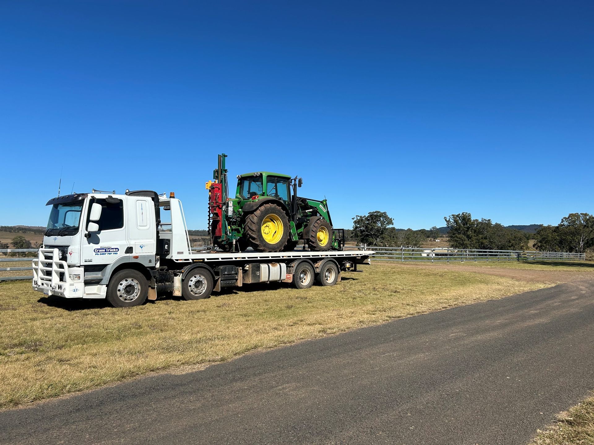 A Truck With A Bulldozer On The Back Of It — Kingaroy Crane Trucks & Equipment Hire In Nanango, QLD