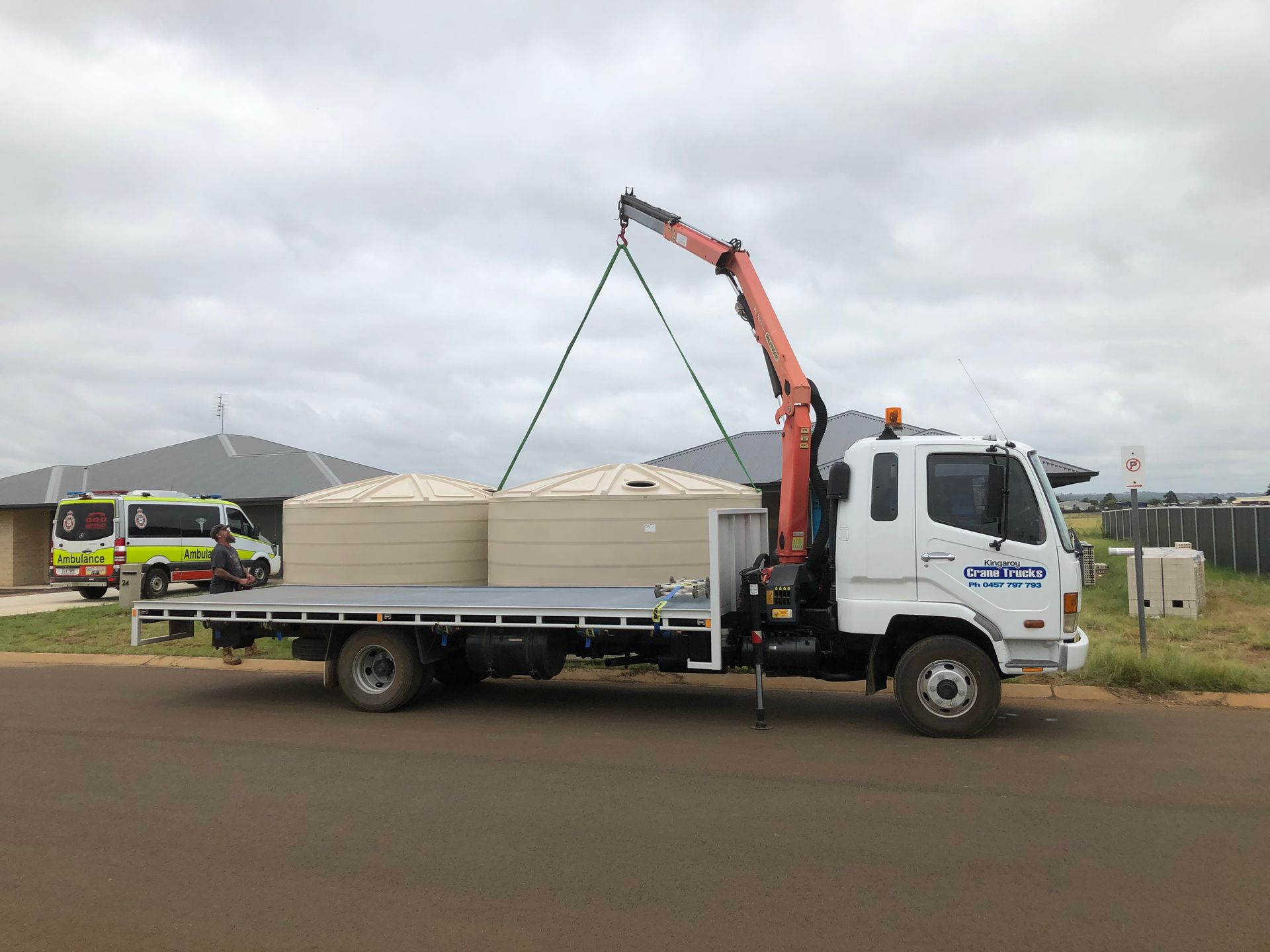 A Truck Is Being Lifted By A Crane On A Construction Site — Kingaroy Crane Trucks & Equipment Hire In Kingaroy, QLD