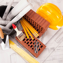 Construction tools, rolled blueprints, bricks, ruler, and yellow hard hat on architectural plans