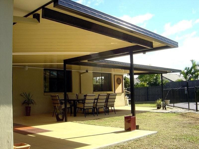A patio with a table and chairs under a canopy