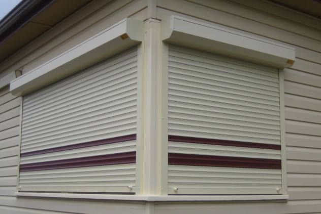 A White House With A Window With Rolling Shutters On It – East Gippsland, VIC - East Gippsland Garage Doors & Maintenance