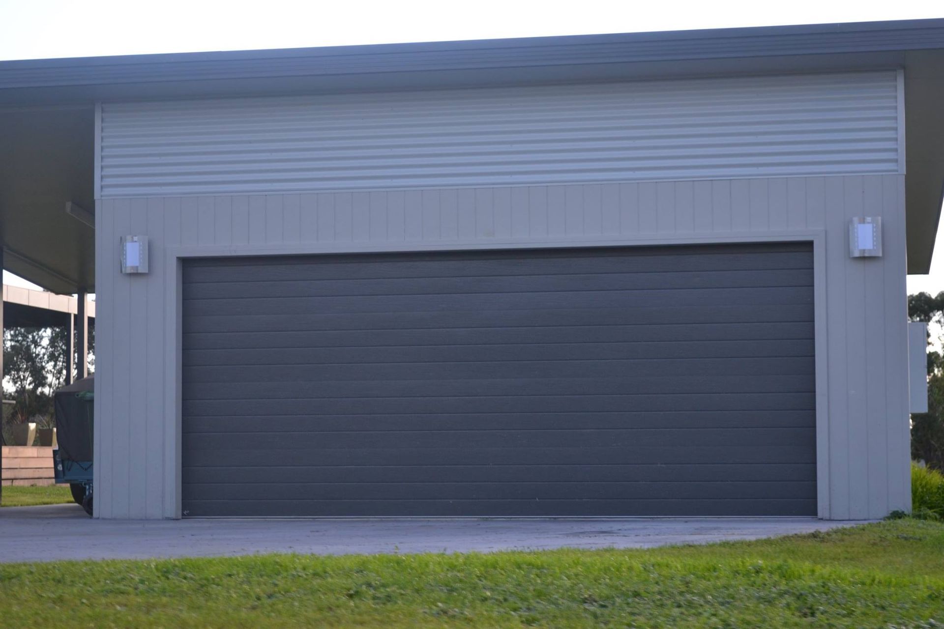 Large Garage With Black Door On A Lush Green Field – East Gippsland, VIC - East Gippsland Garage Doors & Maintenance