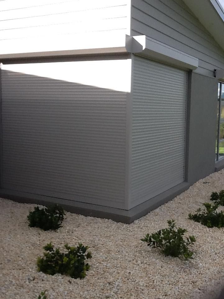 A House With A Gray Shutter On The Side Of It – East Gippsland, VIC - East Gippsland Garage Doors & Maintenance