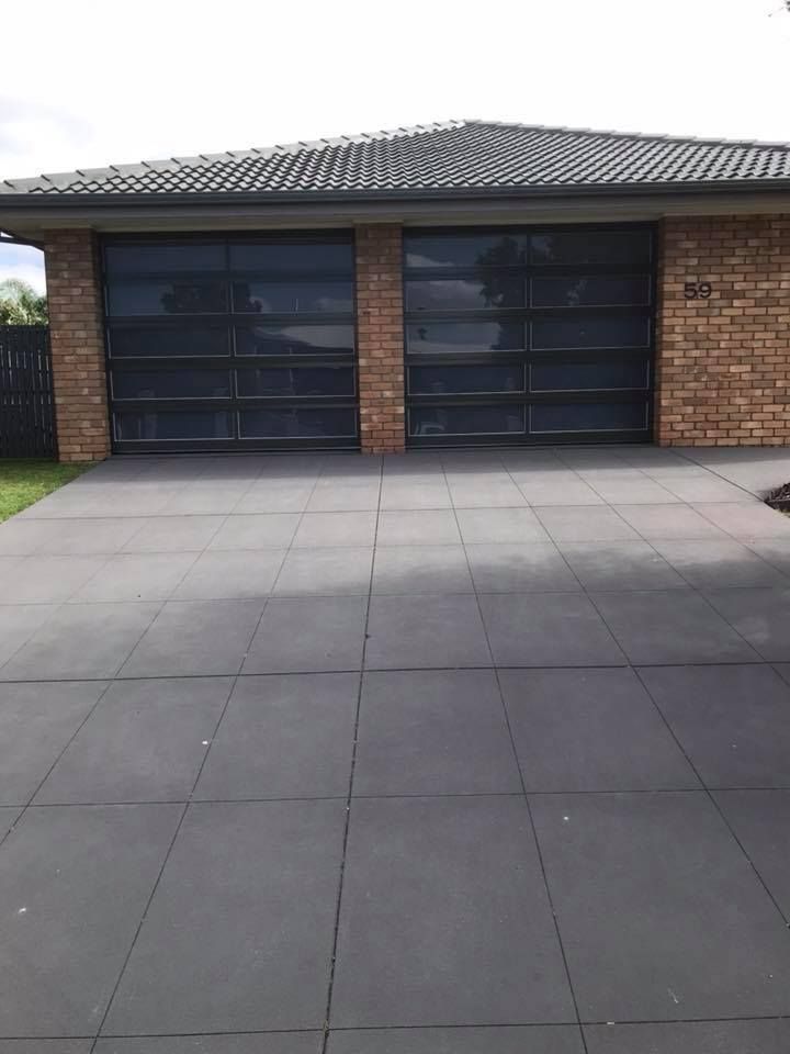 A Brick House With A Large Garage Door And A Driveway – East Gippsland, VIC - East Gippsland Garage Doors & Maintenance