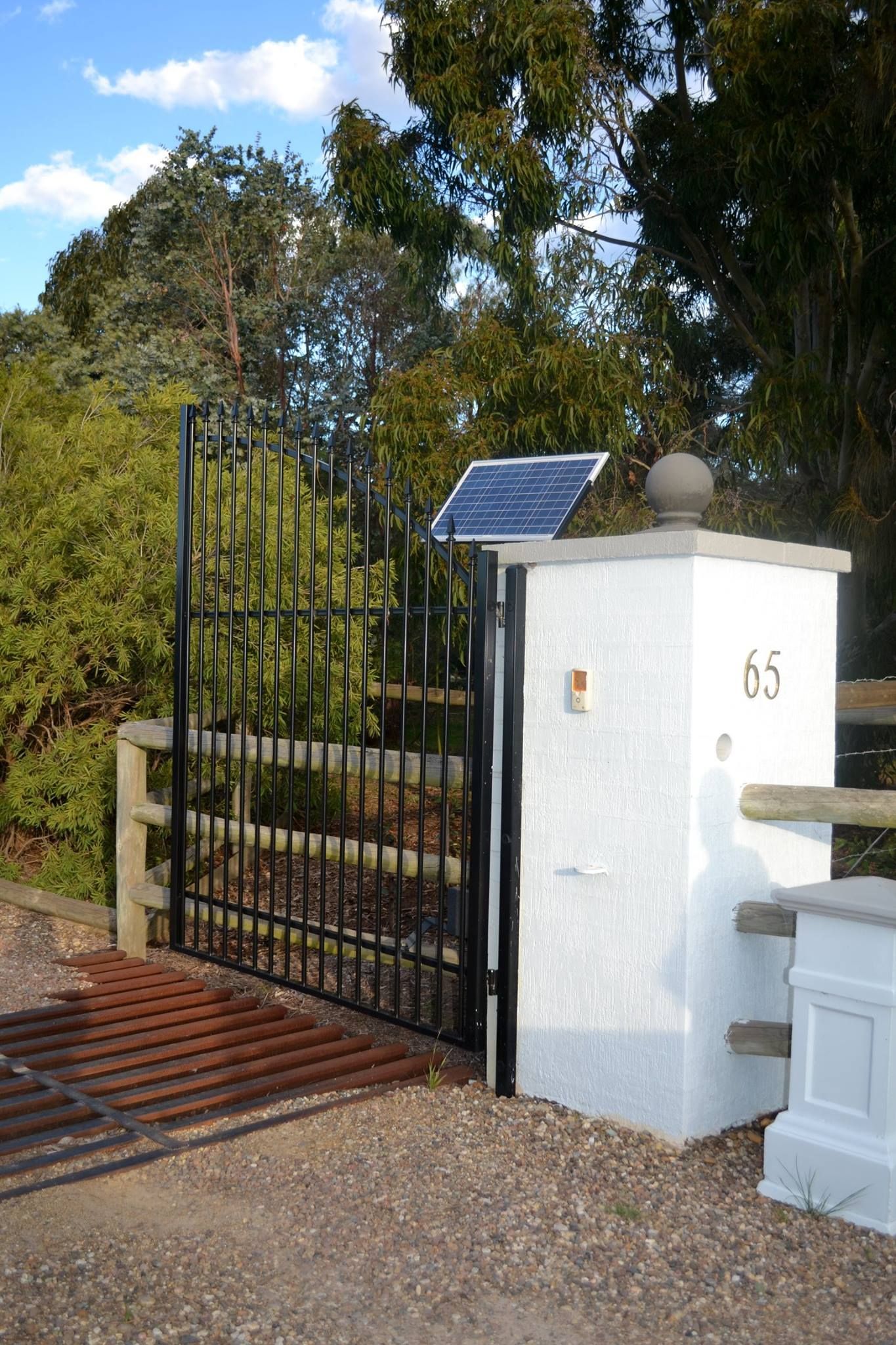 A White Pillar With Black Gate – East Gippsland, VIC - East Gippsland Garage Doors & Maintenance