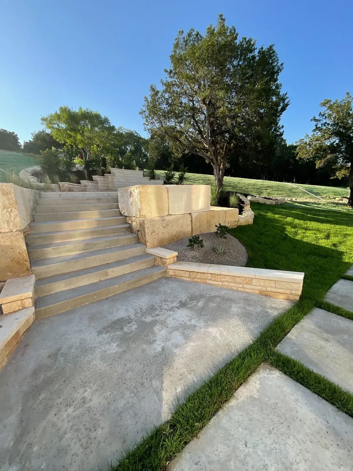 A set of stairs leading up to a lush green field