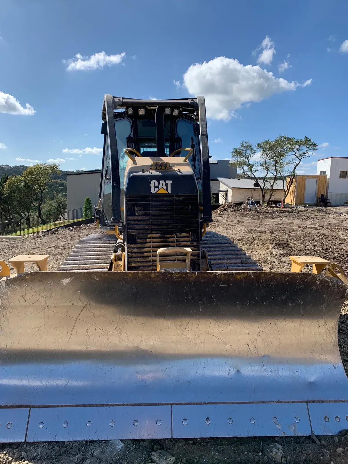 A bulldozer is sitting on top of a dirt field.
