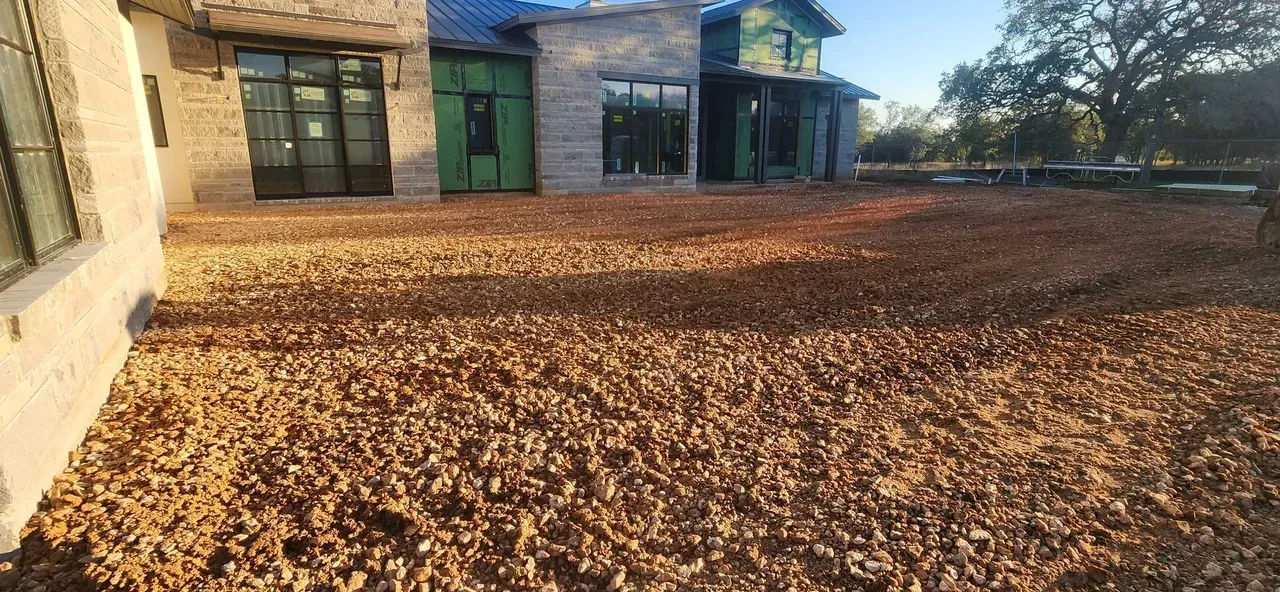 A large house with a lot of leaves on the ground in front of it.