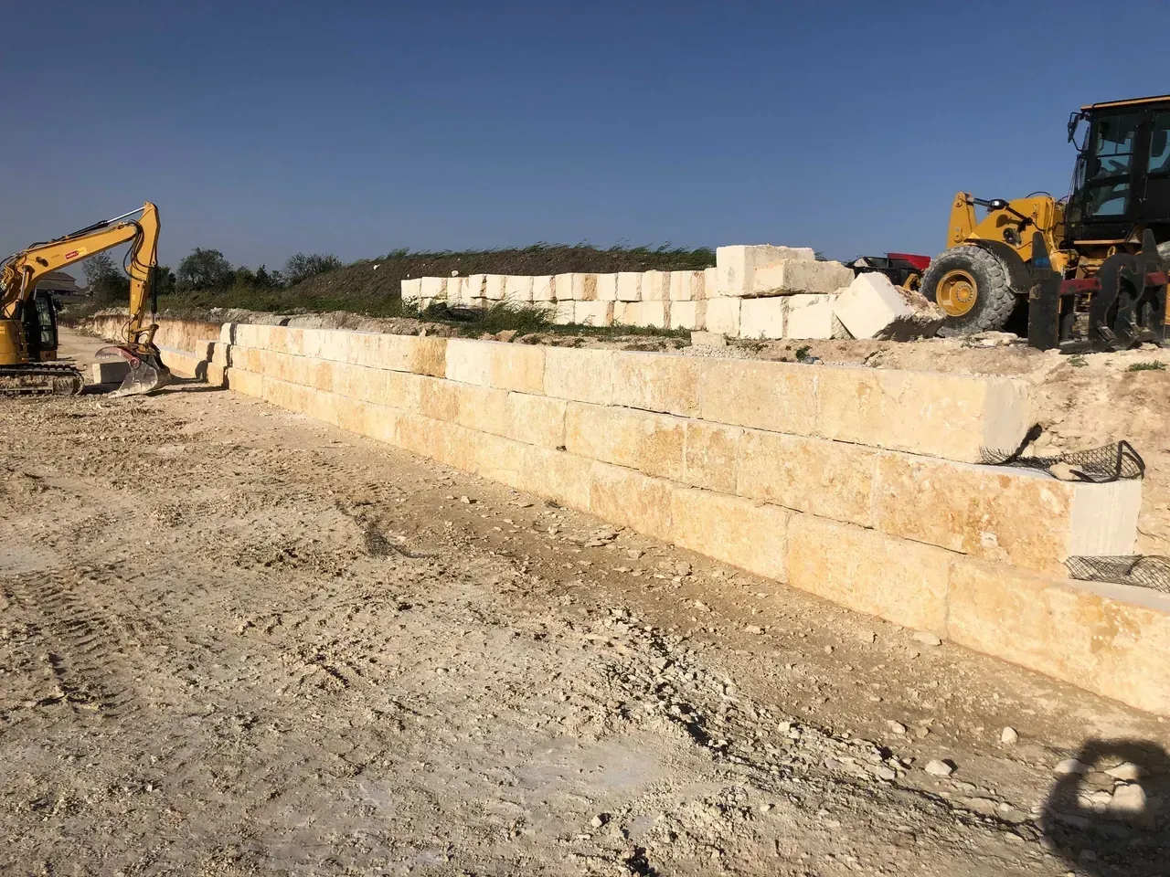 A construction site with a tractor and a bulldozer.