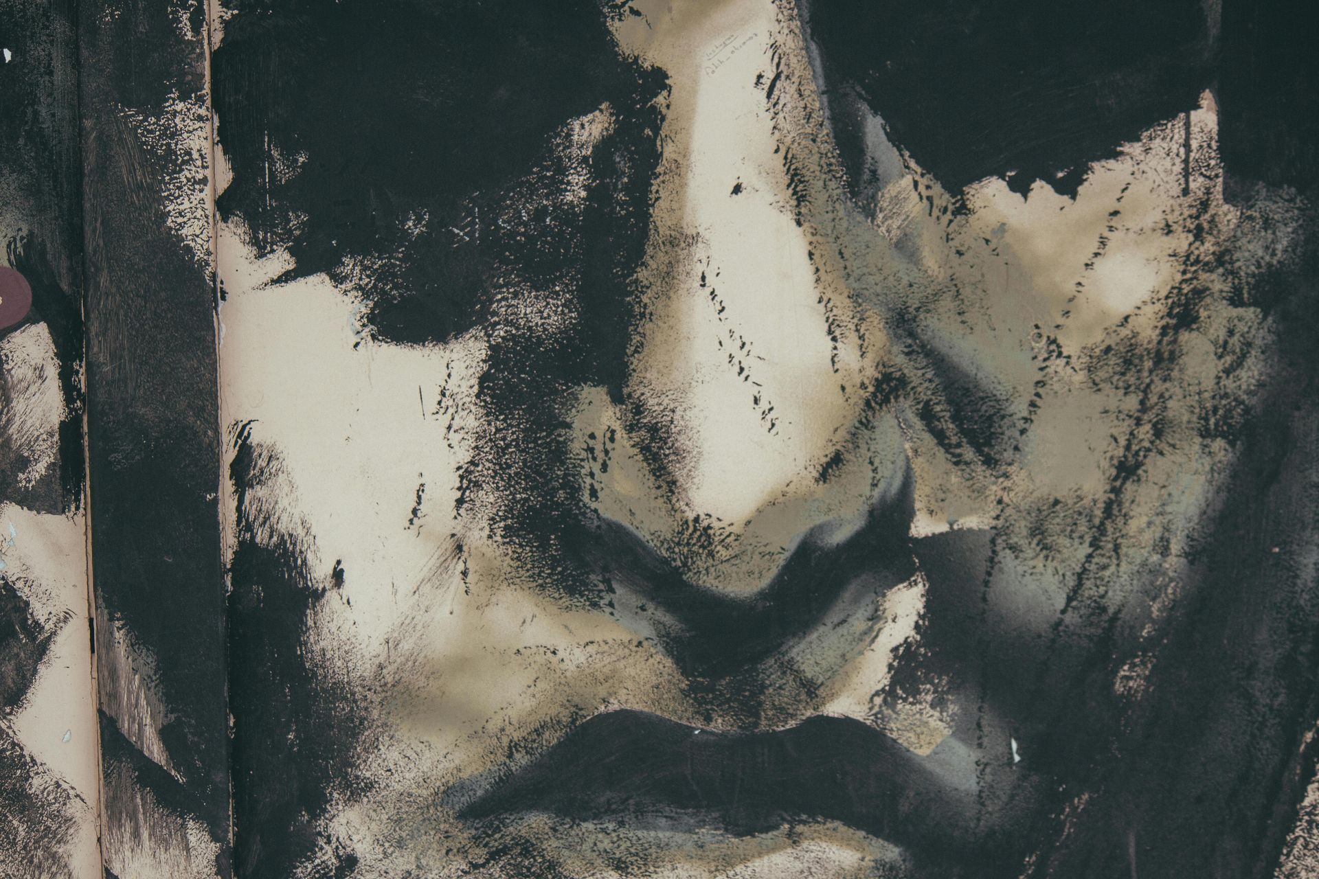 Abstract painting of a face, using dark and neutral tones with brushstroke textures.