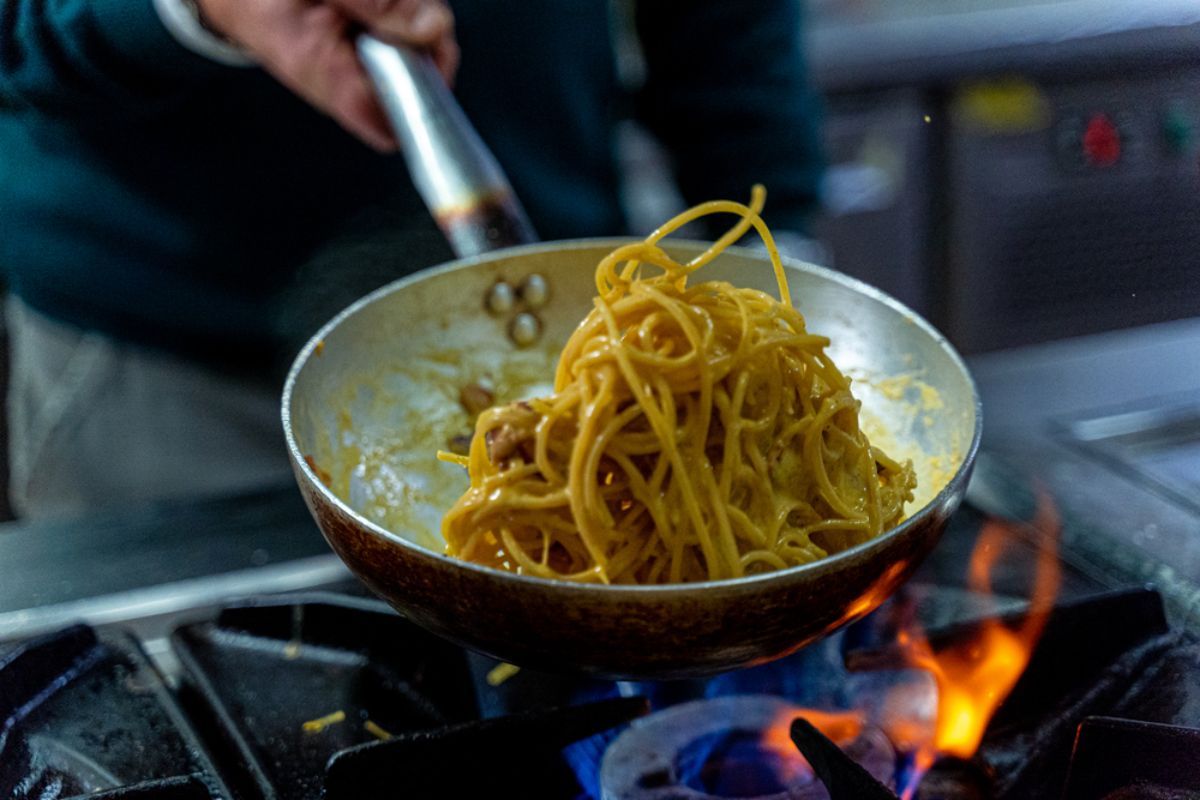 preparation of a first course in typical Roman cuisine