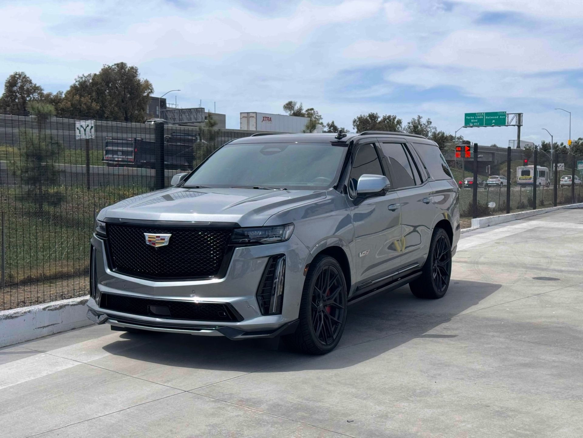 Cadillac Escalade V posing for a photo outside of our shop.