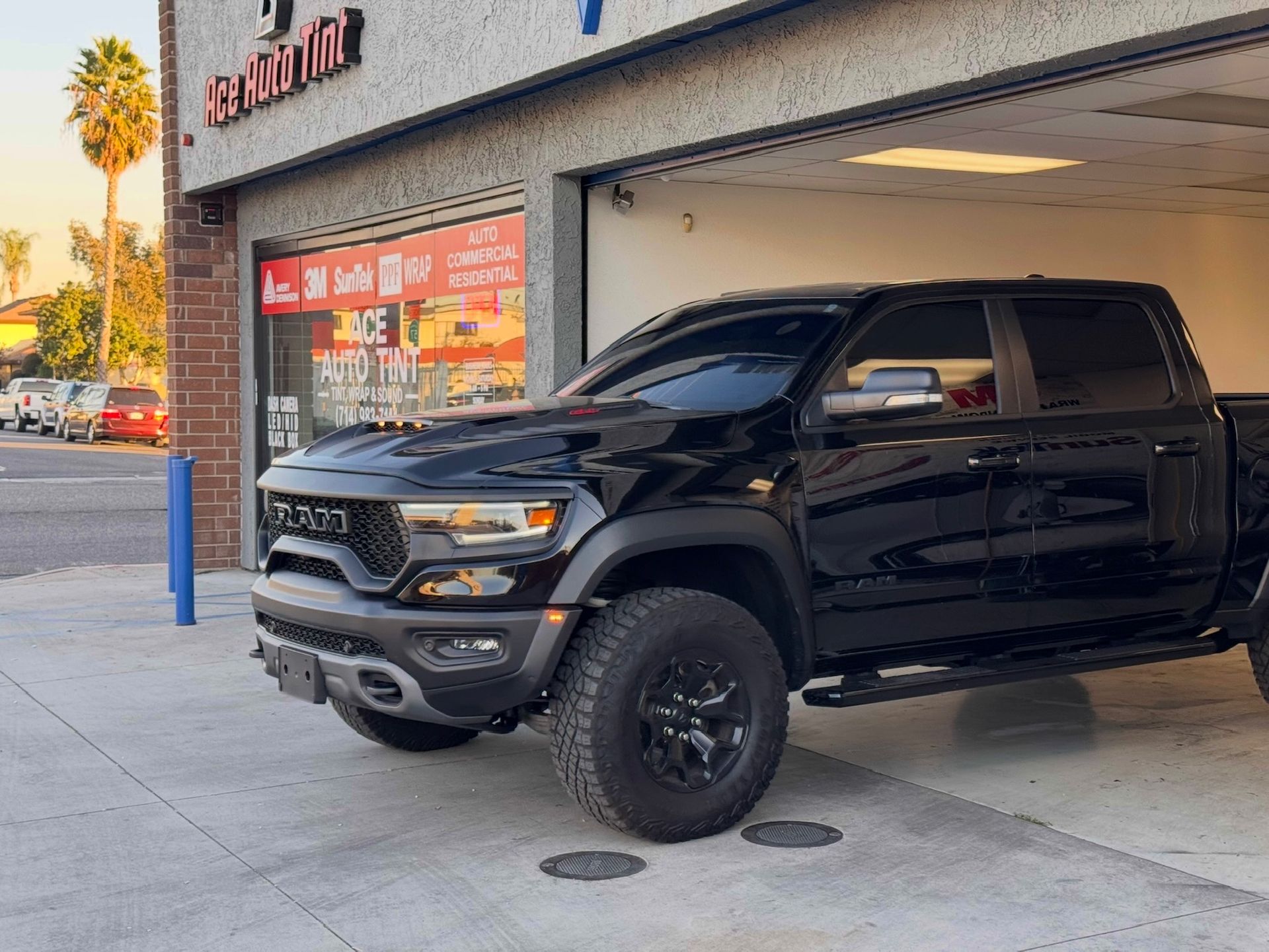 Dodge Ram TRX posing exiting the garage after getting tint done.