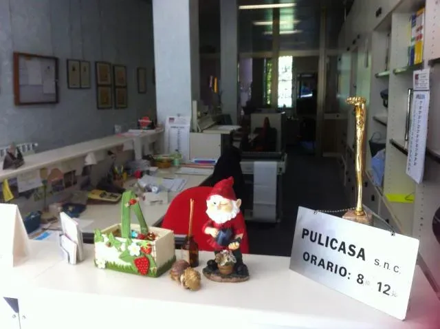 Piccola scrivania da ufficio con una decorazione di Babbo Natale e un cartello con la scritta