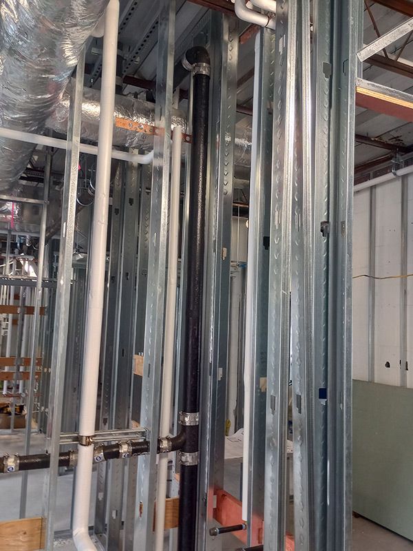 A building under construction with a lot of pipes