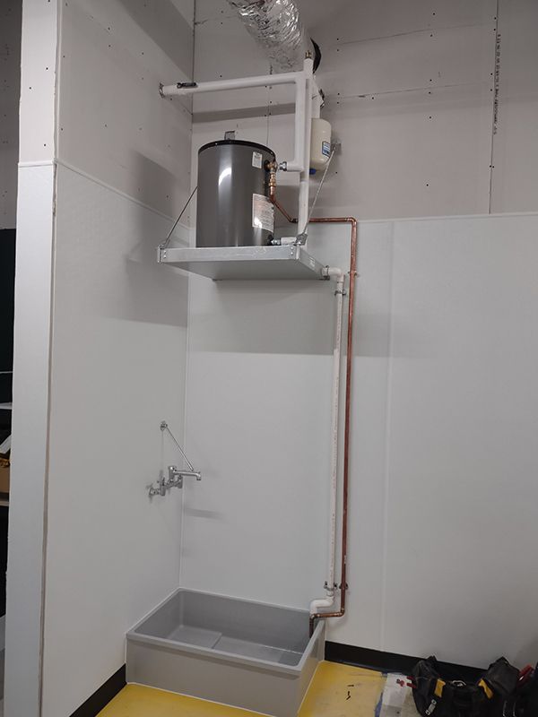 A room with a water heater hanging from the ceiling