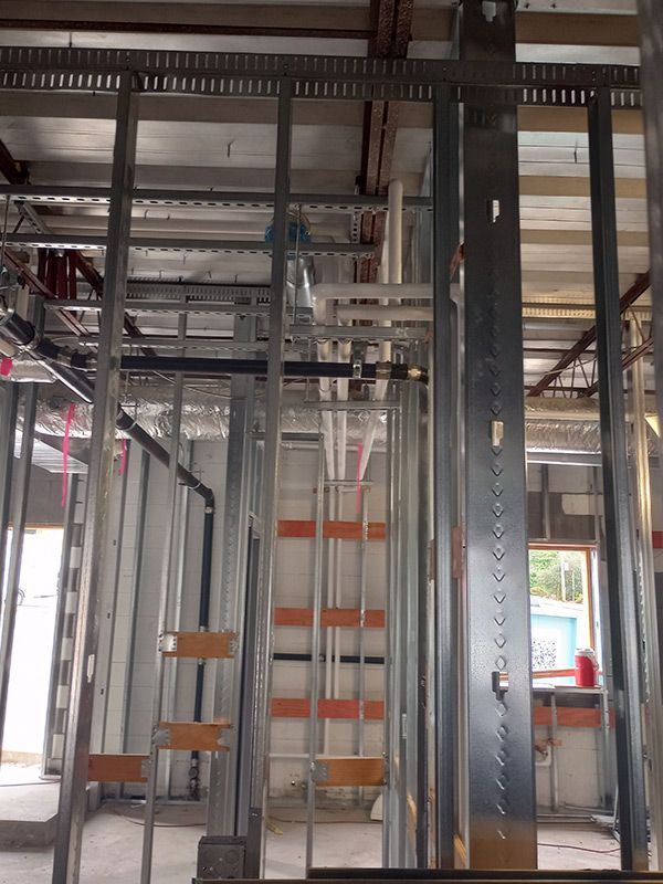 A building under construction with a ladder in the middle