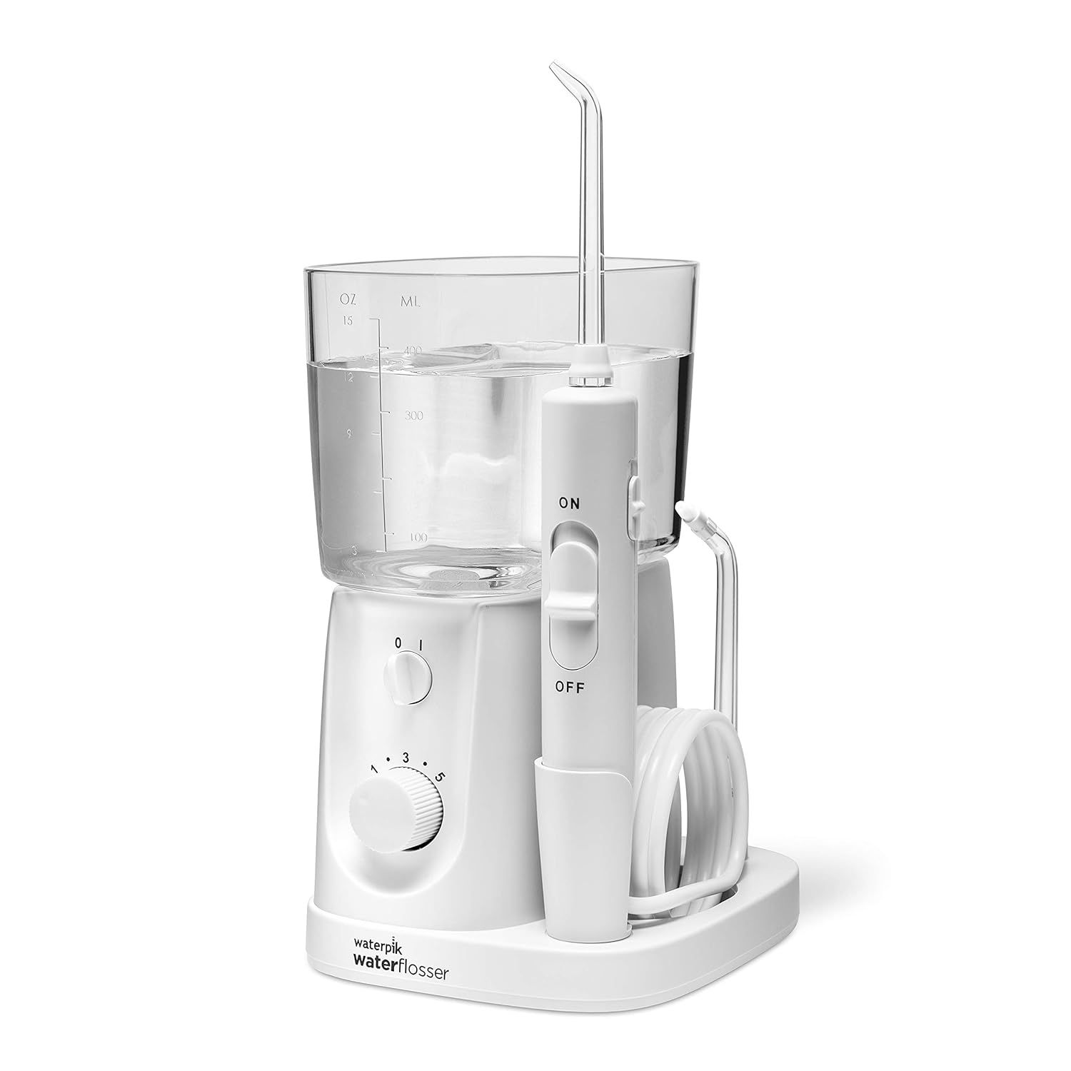 A white countertop water flosser with a transparent reservoir, a handheld nozzle, and a rotary pressure control dial.