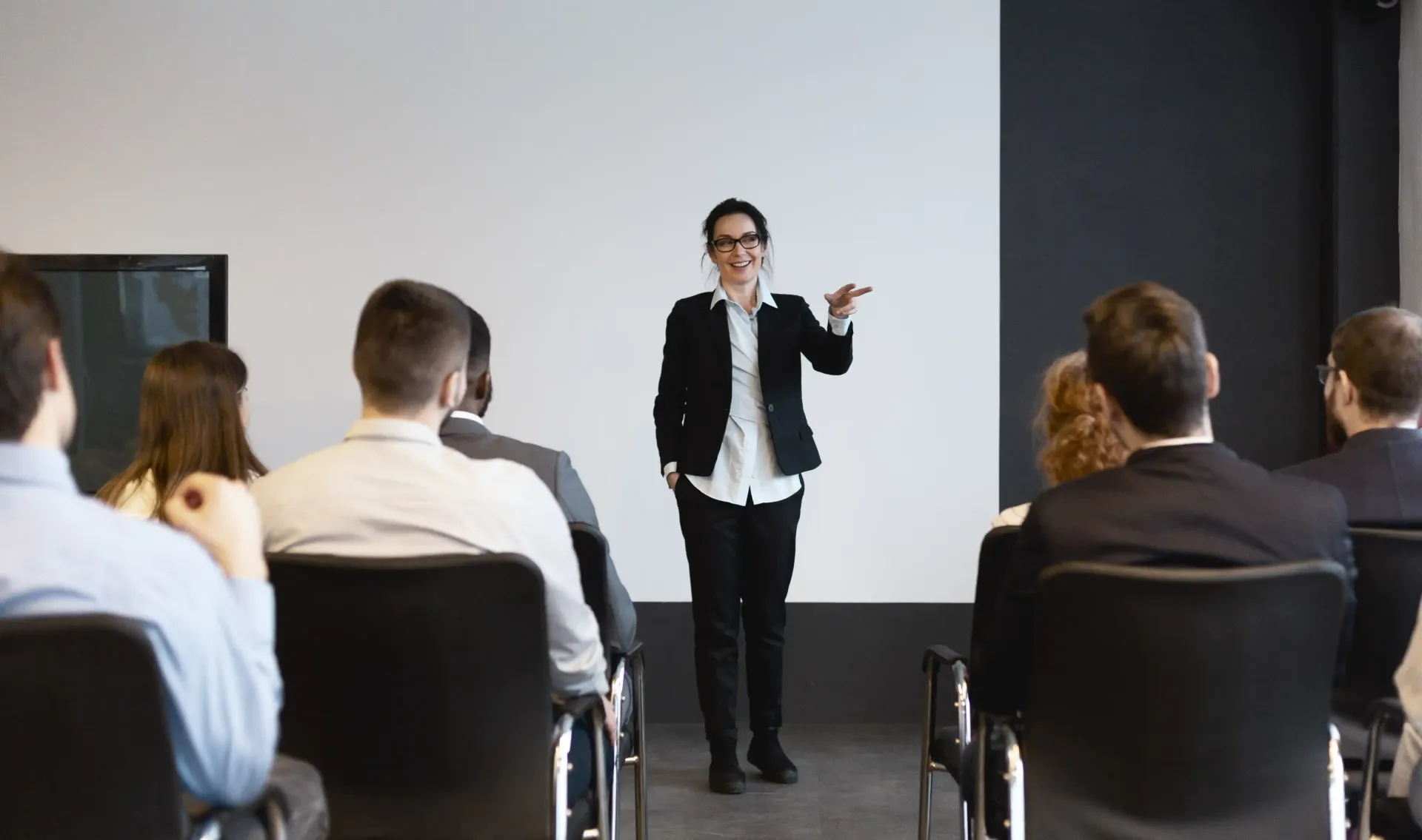 Motivational speaker Katherine Mirrer engaging a team during a talk on productivity and setting goals.