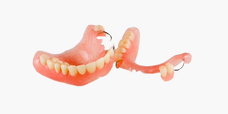 False teeth, full upper and partial lower dentures, pink plastic, white teeth.