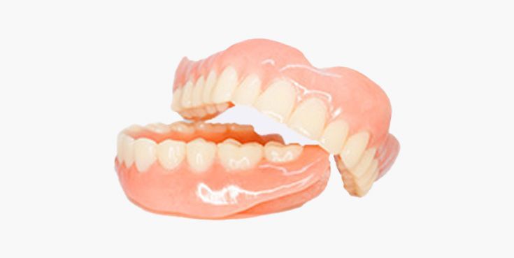 Set of upper and lower dentures with pink gums and white teeth.