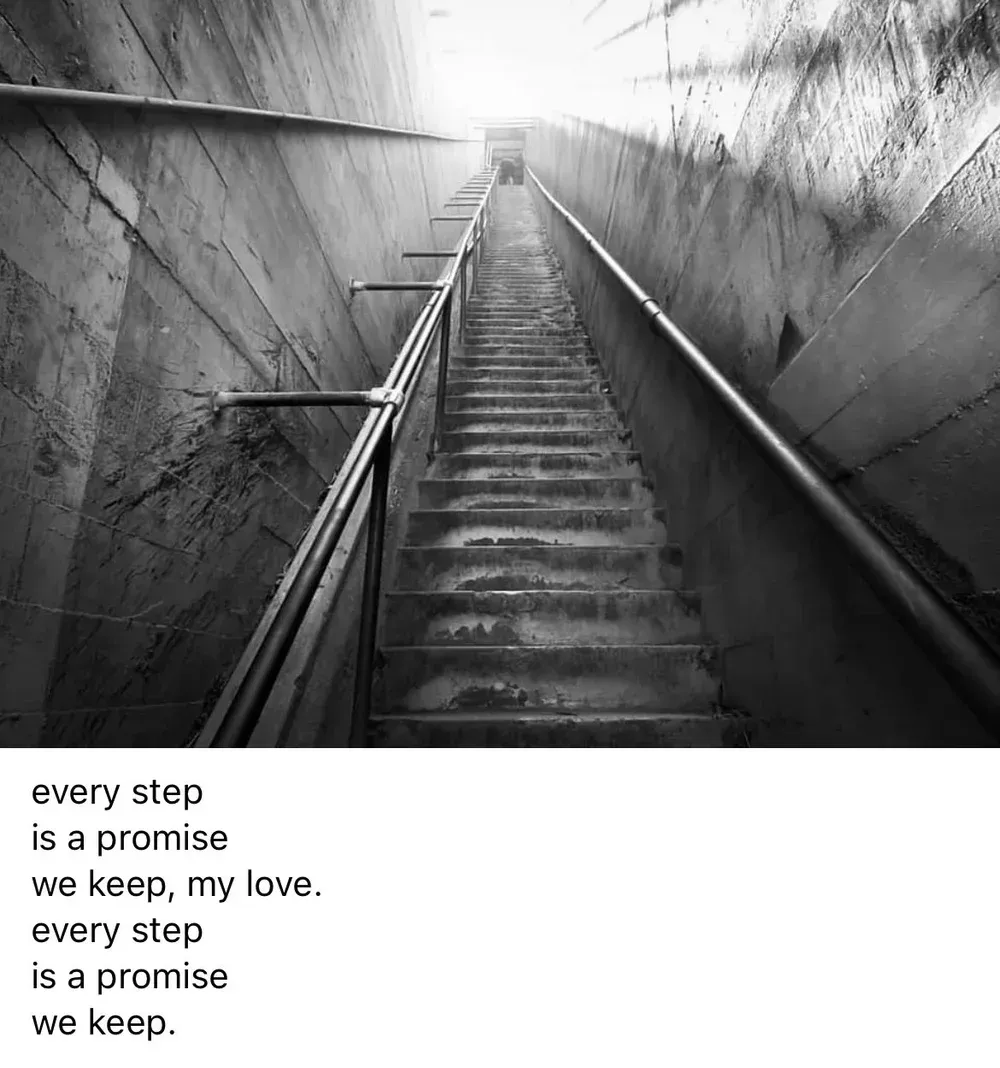 Black and white photo of a long staircase leading to bright light. Text overlay: 