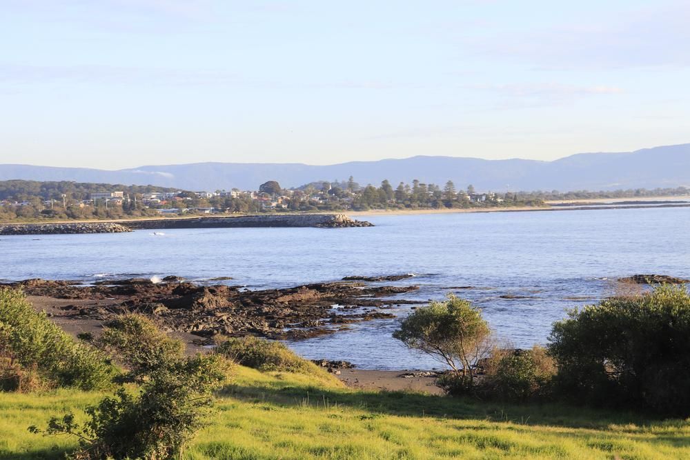 A Large Body Of Water With Mountains In The Background — Chris Stolk Constructions In Shellharbour, NSW