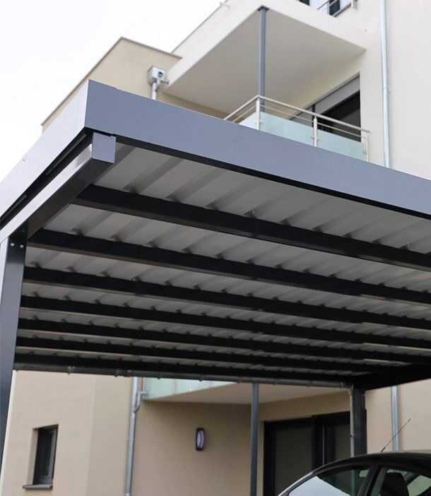 A Car Is Parked Under A Canopy In Front Of A Building — Chris Stolk Constructions In Kanahooka, NSW