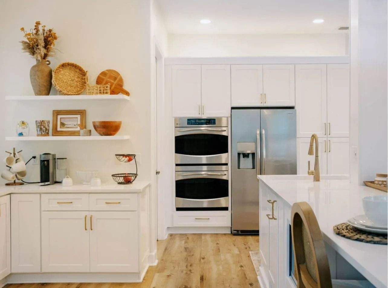 A kitchen with white cabinets and stainless steel appliances.