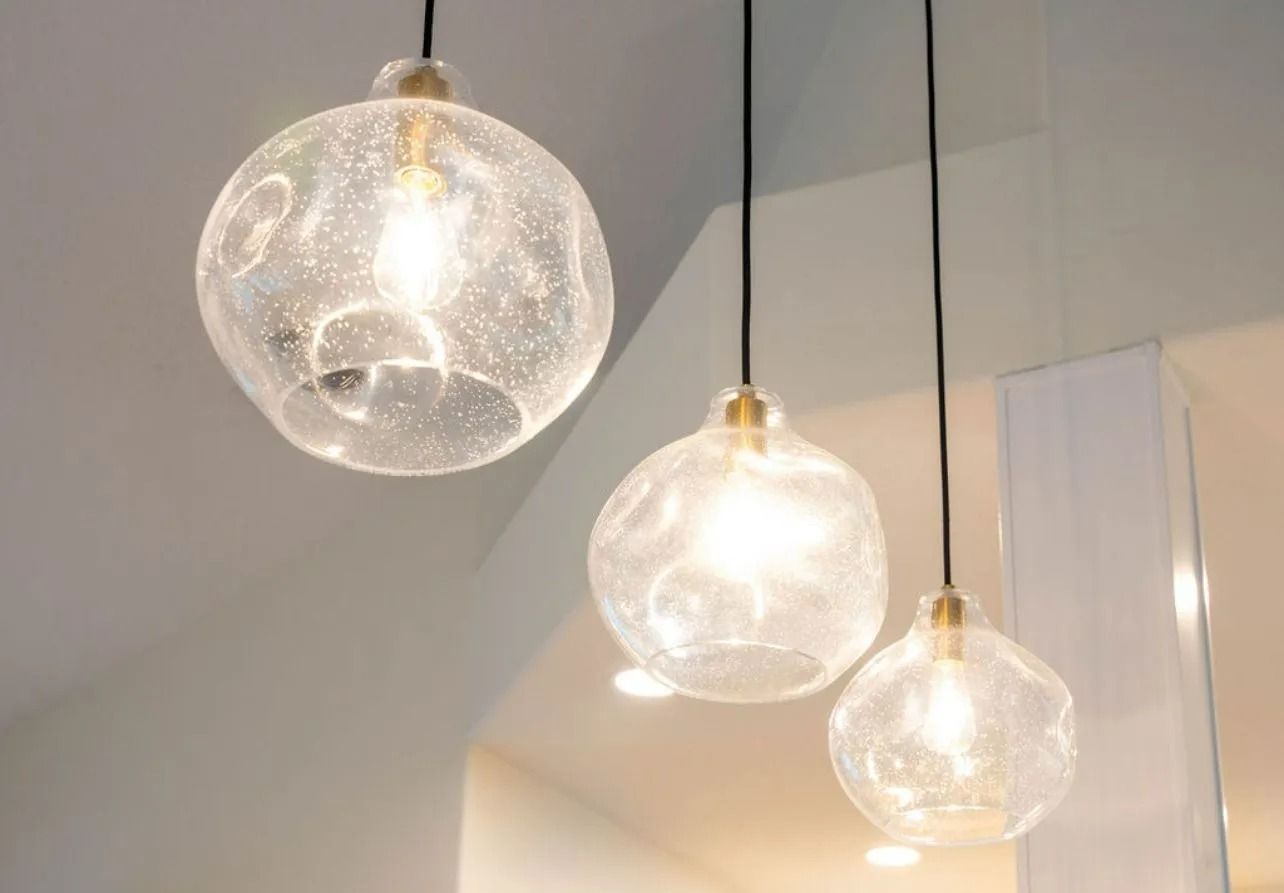 Three clear glass pendant lights are hanging from the ceiling.