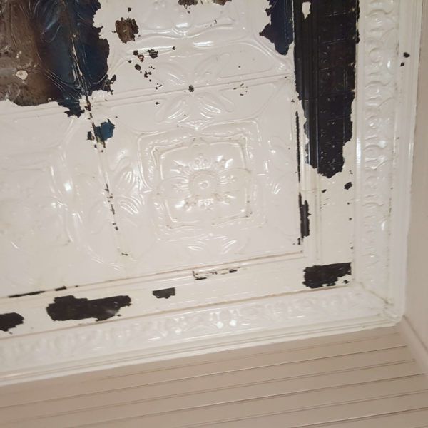 A white fresco ceiling with paint chips on it — Axis Painting in Coffs Harbour, NSW